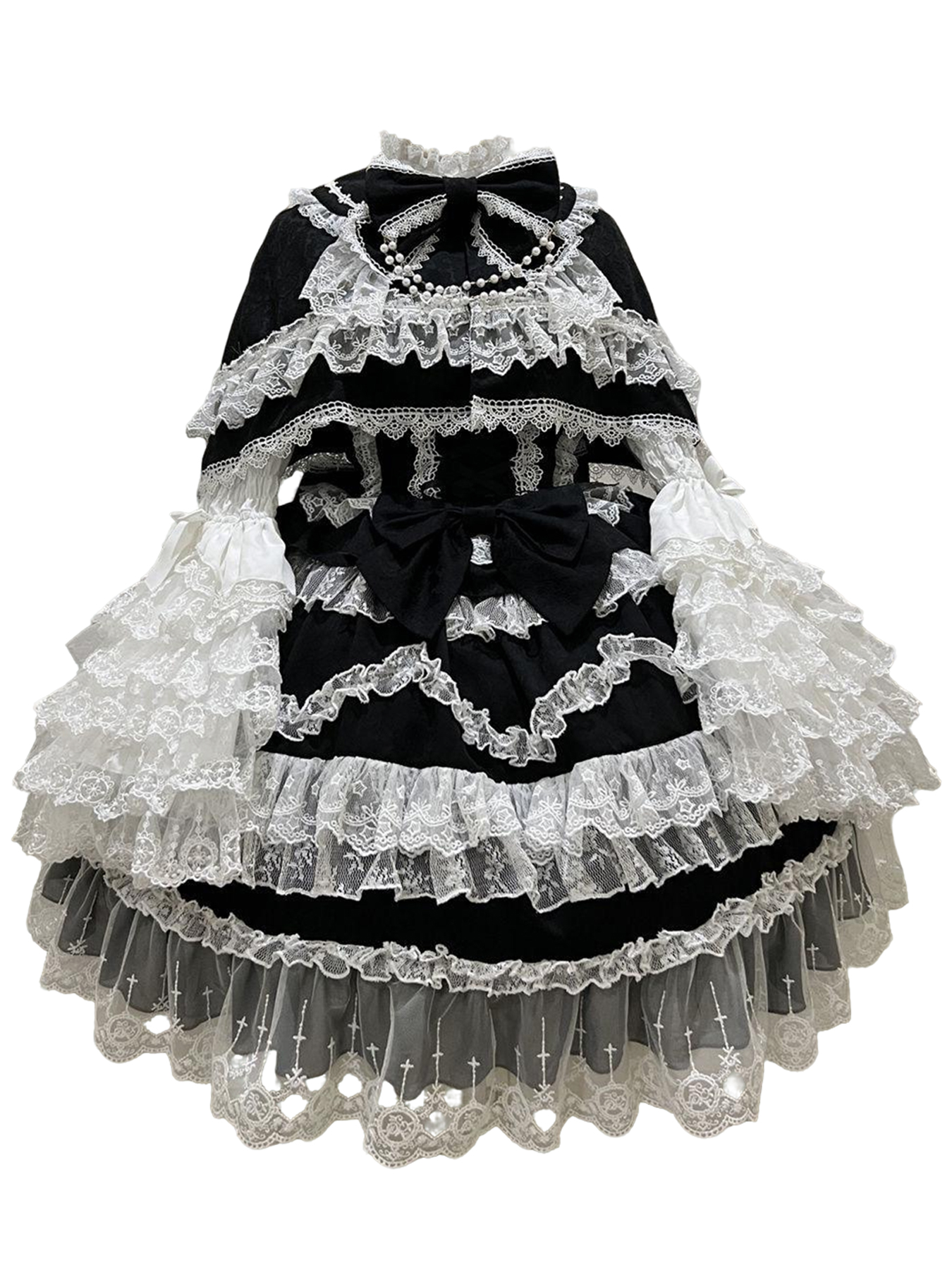 Model wearing a black and white classic Lolita JSK dress with lace, ruffles, bows, and pearl details, paired with a white blouse and headpiece.